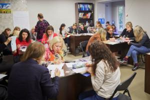 Ukrainalaisia naisia pöytien ääressä kirjoittamassa